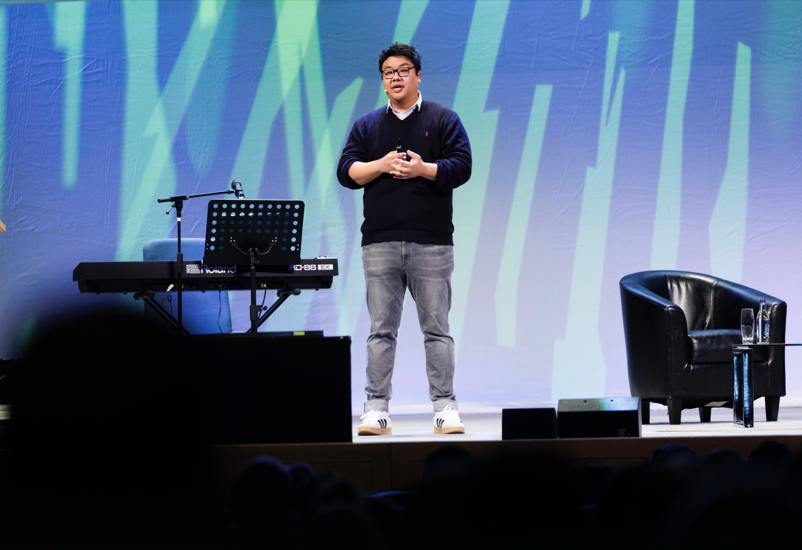 Tiankai Feng speaking on stage at a data and AI conference