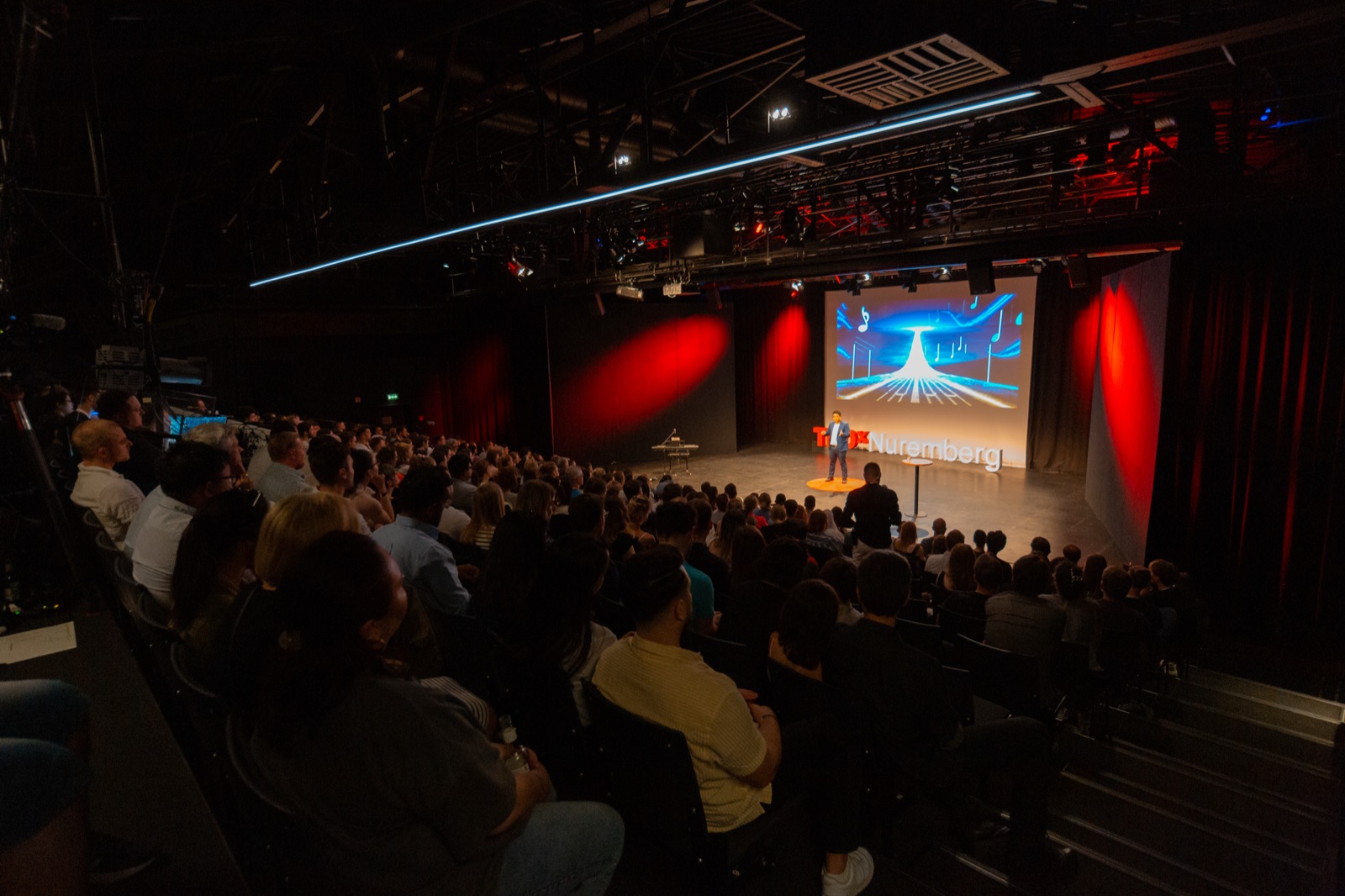 Tiankai Feng speaking on the TEDxNuremberg stage with the TEDxNuremberg logo visible